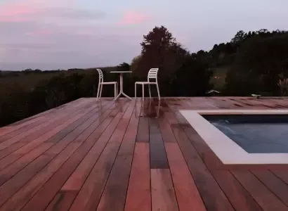 Timber deck around a pool at sunset